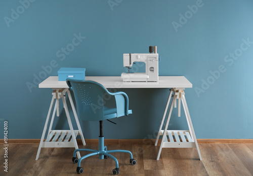 Sewing machine on table in ...