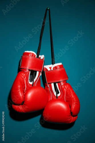 Boxing gloves on color background © Africa Studio