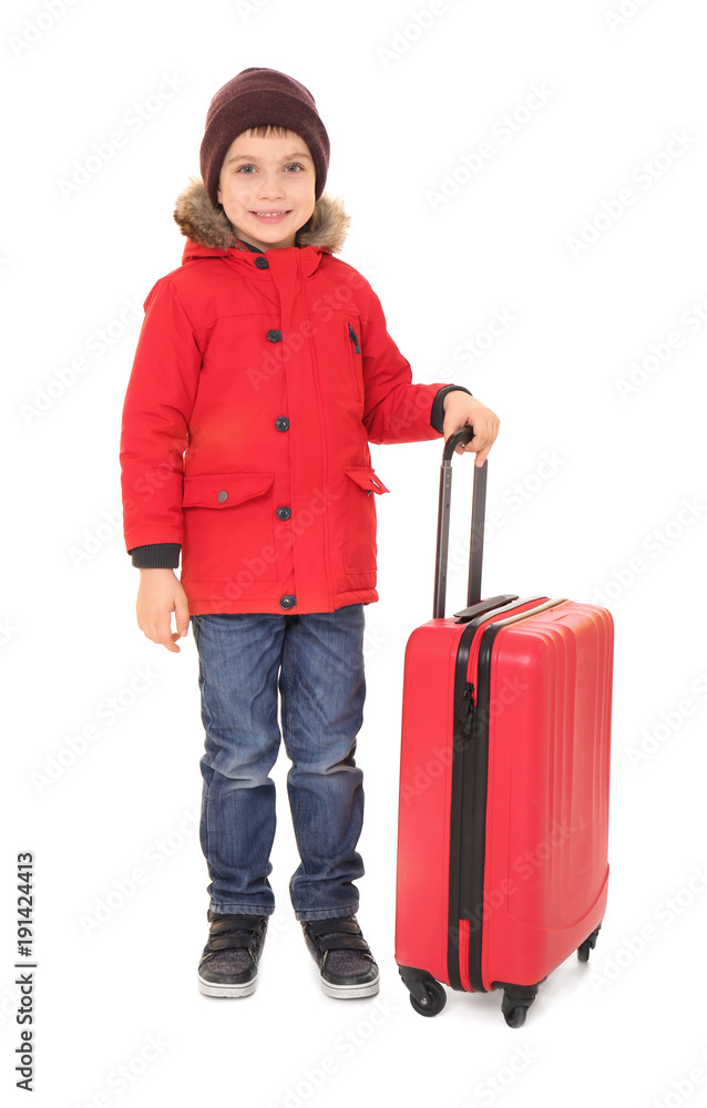 Cute little boy in warm clothing and luggage on white background. Ready for winter vacation Cute little boy in warm clothing and luggage on white background. Ready for winter vacation
