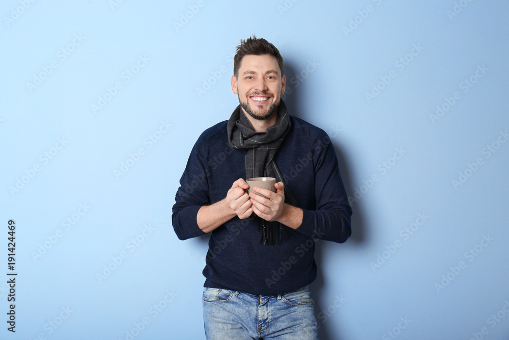 Young man in warm clothing on color background. Ready for winter vacation Young man in warm clothing on color background. Ready for winter vacation