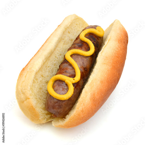 Grilled Bratwurst with mustard on bun. Isolated.
