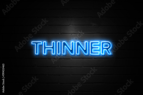 Thinner neon Sign on brickwall photo