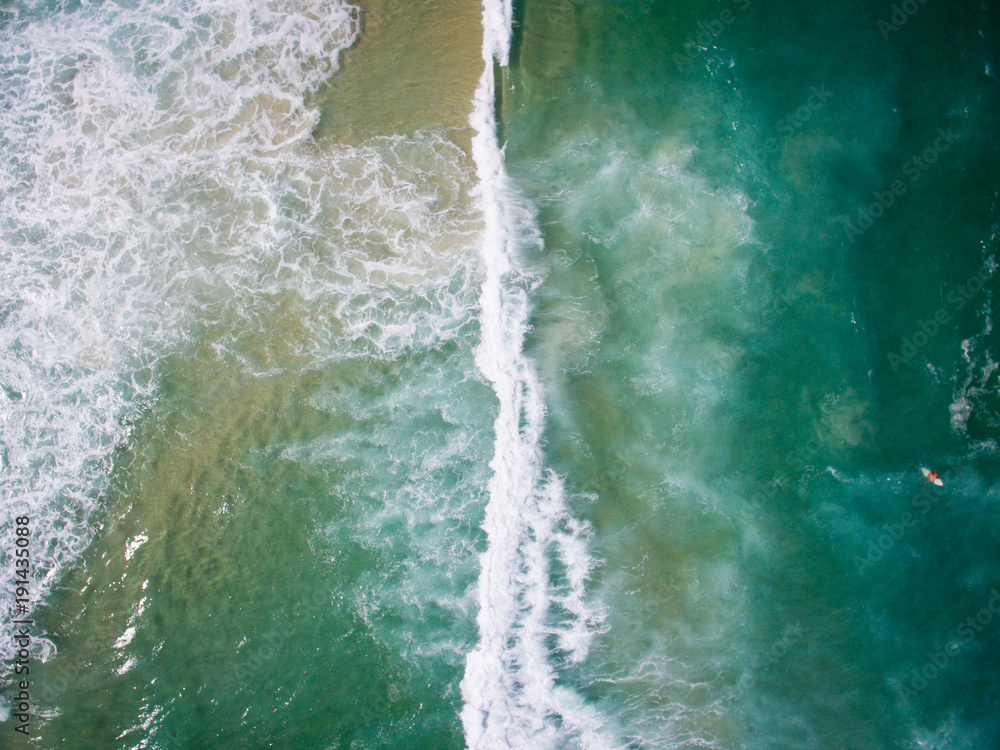 drone photo of the waves  crashing on the ocean in Barra da Tiju
