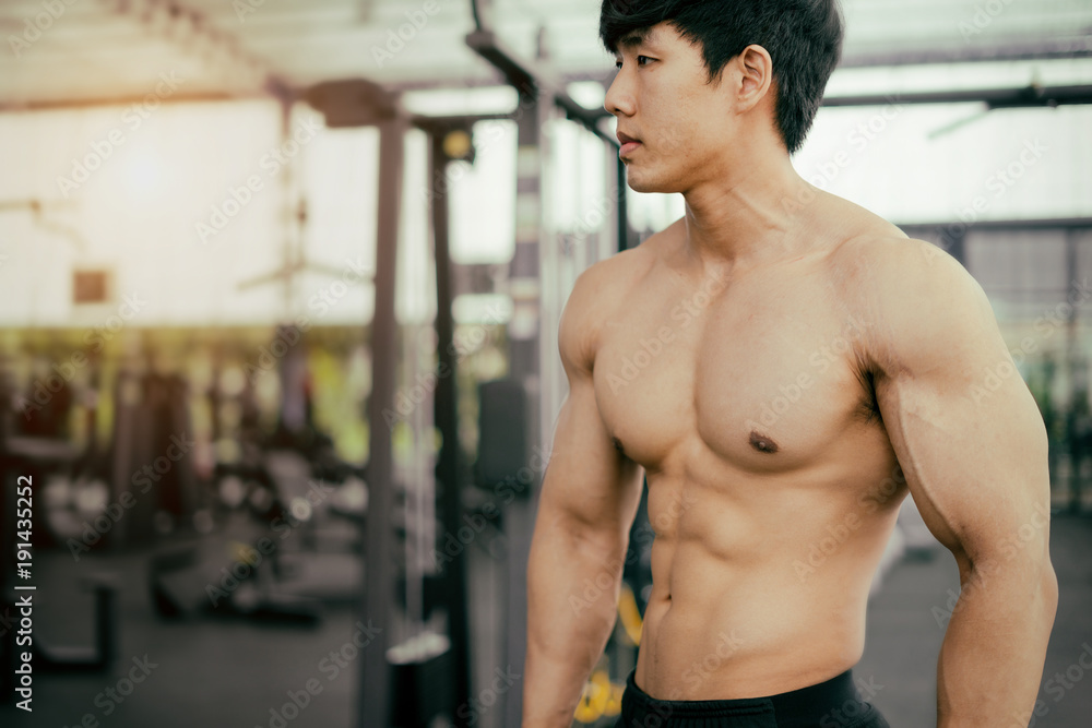 strong fitness man posing muscular body and doing exercises for bodybuilder in the gym, fitness concept, sport concept strong fitness man posing muscular body and doing exercises for bodybuilder in the gym, fitness concept, sport concept