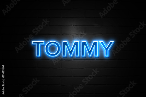 Tommy neon Sign on brickwall photo