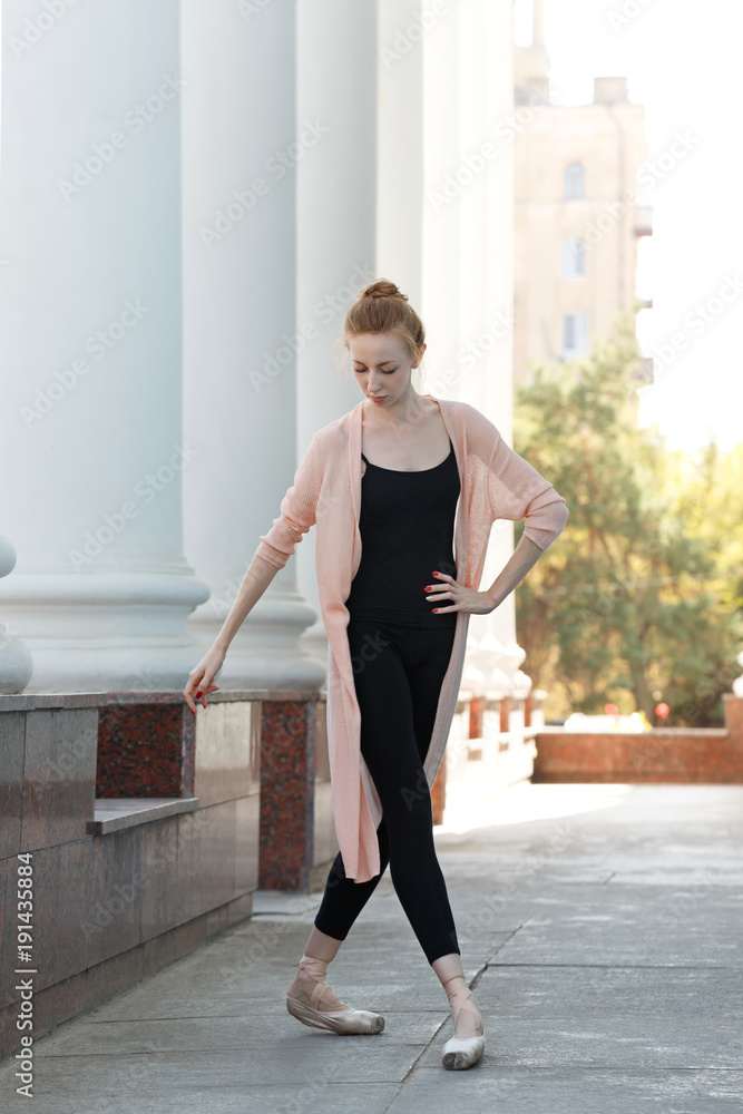 Ballerina is dancing in front of building Ballerina is dancing in front of building