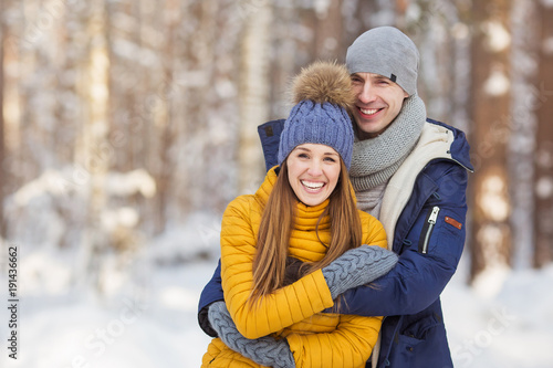 Loving young couple in a forest in the winter