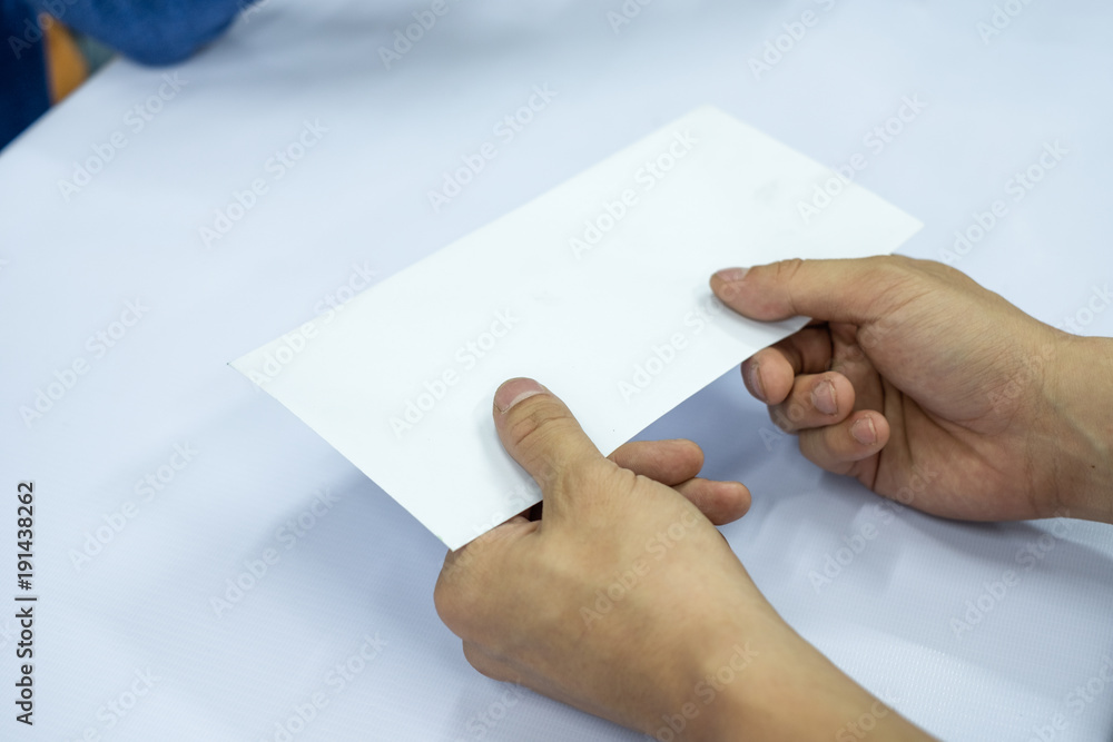 Hand businessman giving blank white envelope Hand businessman giving blank white envelope