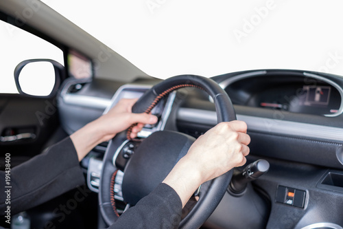 Hand holding steering wheel in modern private car with blank windshield