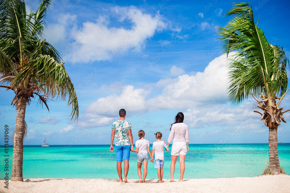 Family of four on the beach on caribbean vacation. Family of four on the beach on caribbean vacation.