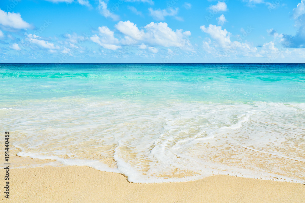Clear aqua blue sea water and white sand tropical beach