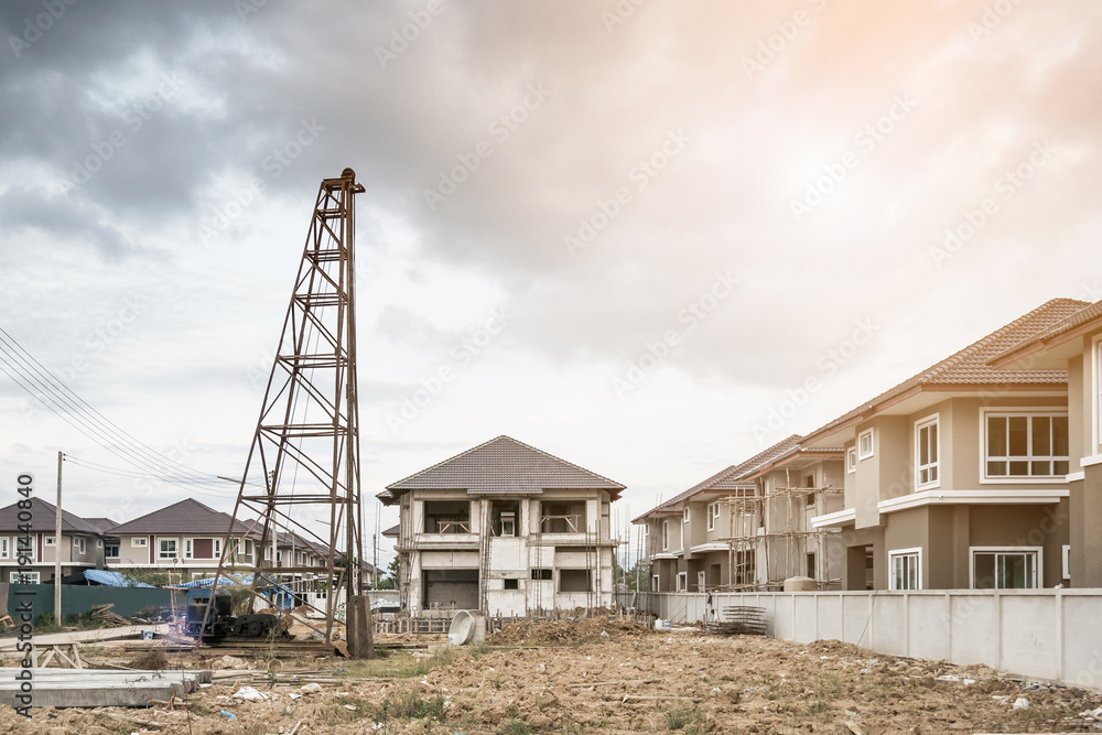 Residential new house building at construction site with clouds and blue sky Residential new house building at construction site with clouds and blue sky