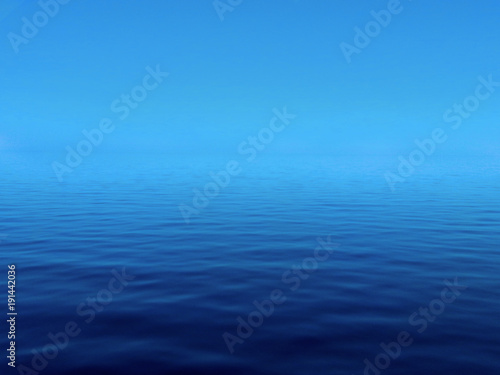 A calm lake vanishes into a blue sky