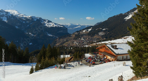 tourist people at ski resort with snow and mountain background