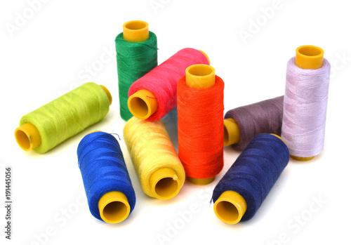 Spool of coloured thread isolated on white background.