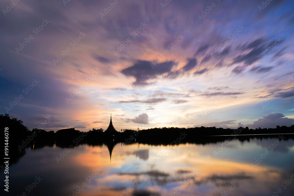 Fototapeta premium Silhouette temple and river in thailand khonkaen landmarks in evening, reflection