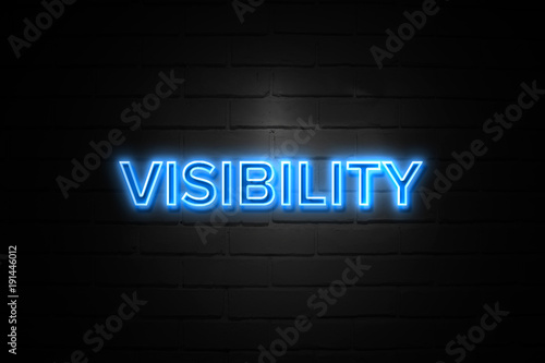Visibility neon Sign on brickwall photo