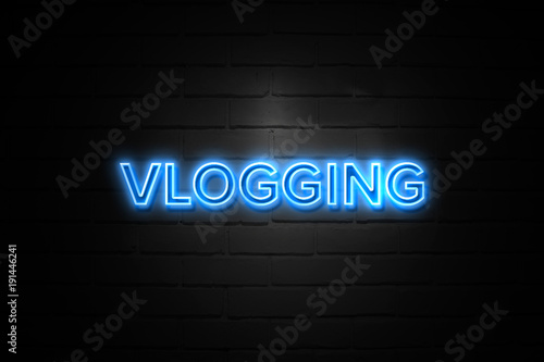 Vlogging neon Sign on brickwall photo