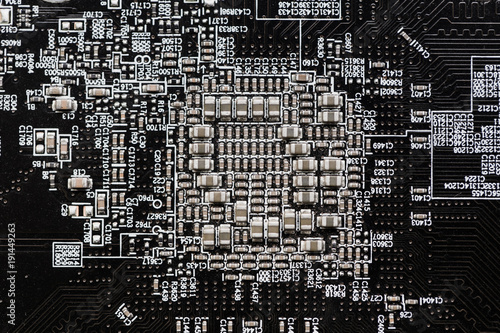 Ceramic Capacitors at Digital electronic circuit board closeup very small type photo