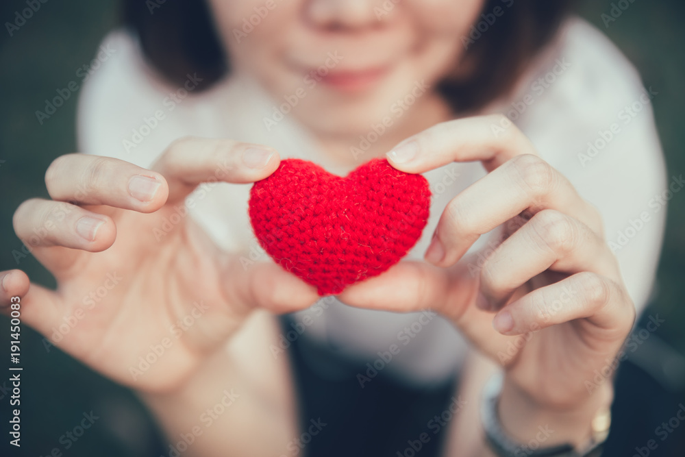 Love and Heart red color on women hand in valentine's day vintage color tone Love and Heart red color on women hand in valentine's day vintage color tone
