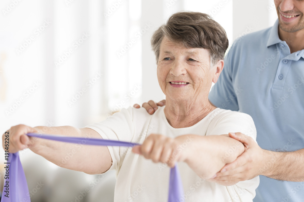 Obraz premium Happy senior woman stretching