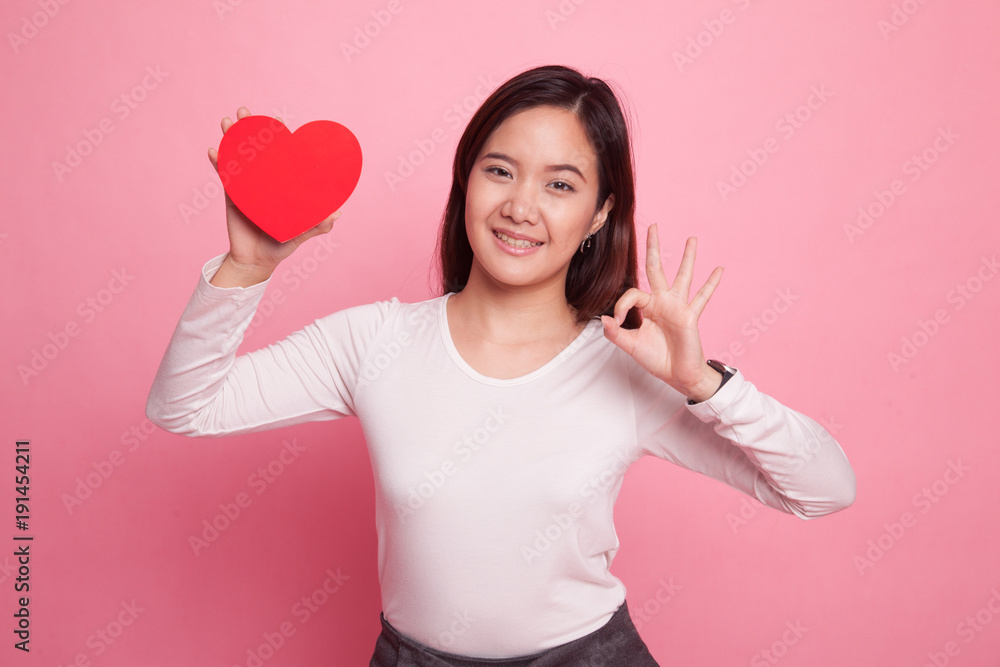 Asian woman show OK with red heart. Asian woman show OK with red heart.