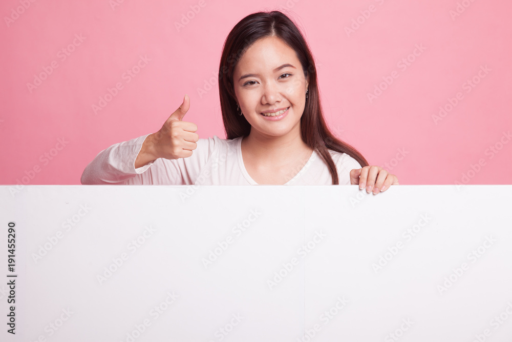 Young Asian woman show thumbs up with blank sign. Young Asian woman show thumbs up with blank sign.