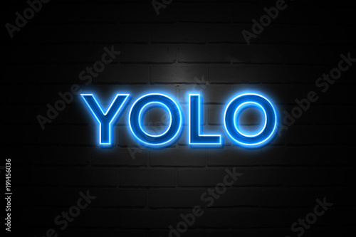 Yolo neon Sign on brickwall photo