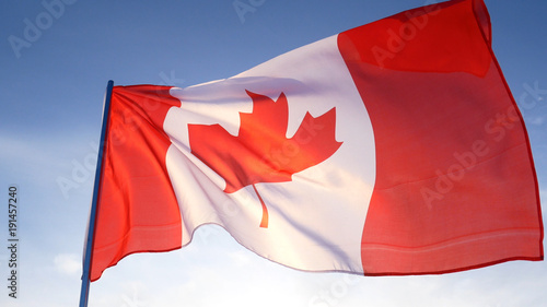 Canada flag on clear blue sky