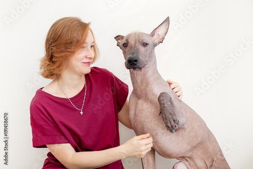 A woman with a Mexican Hairless Dog that gives the paw