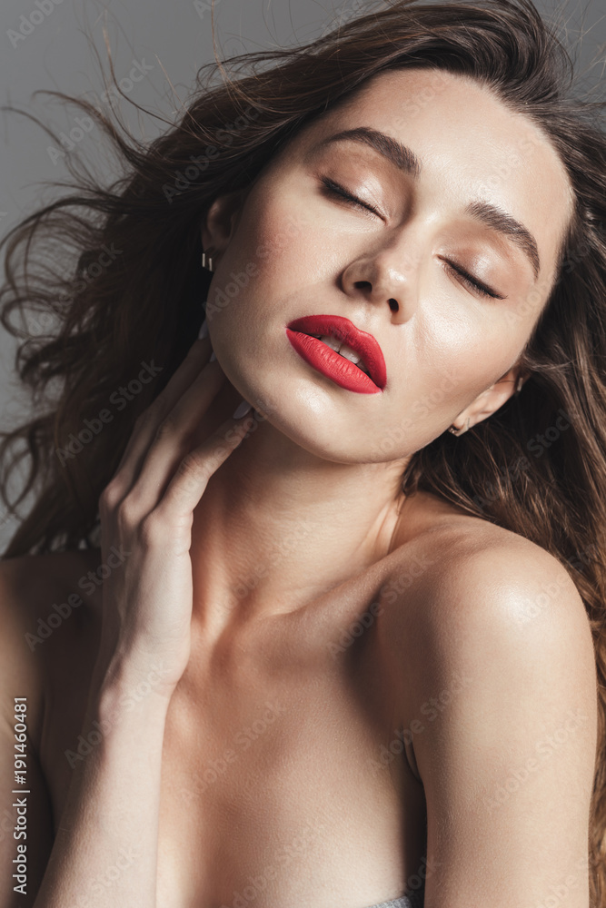 Obraz premium Fashion portrait of a beautiful shirtless curly brown hair woman