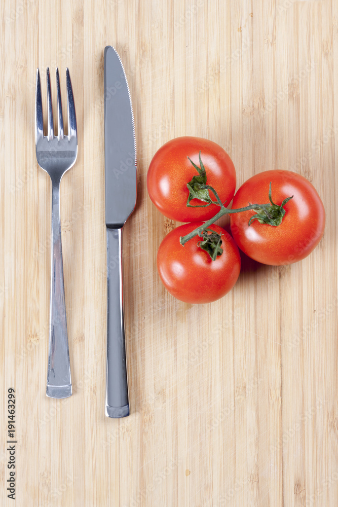 Red fresh tomatoes on chopping board Red fresh tomatoes on chopping board