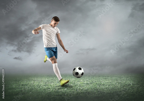 Soccer player on a football field in dynamic action at summer da © Andrii IURLOV