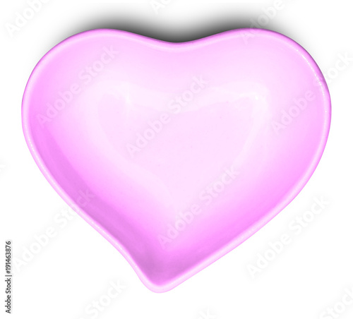 Pink plate in shape of heart isolated on white background.