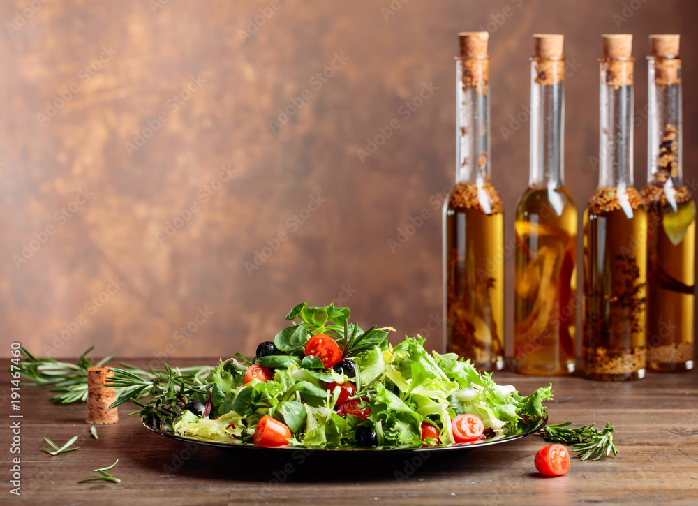 Green salad and olive oil with spices.