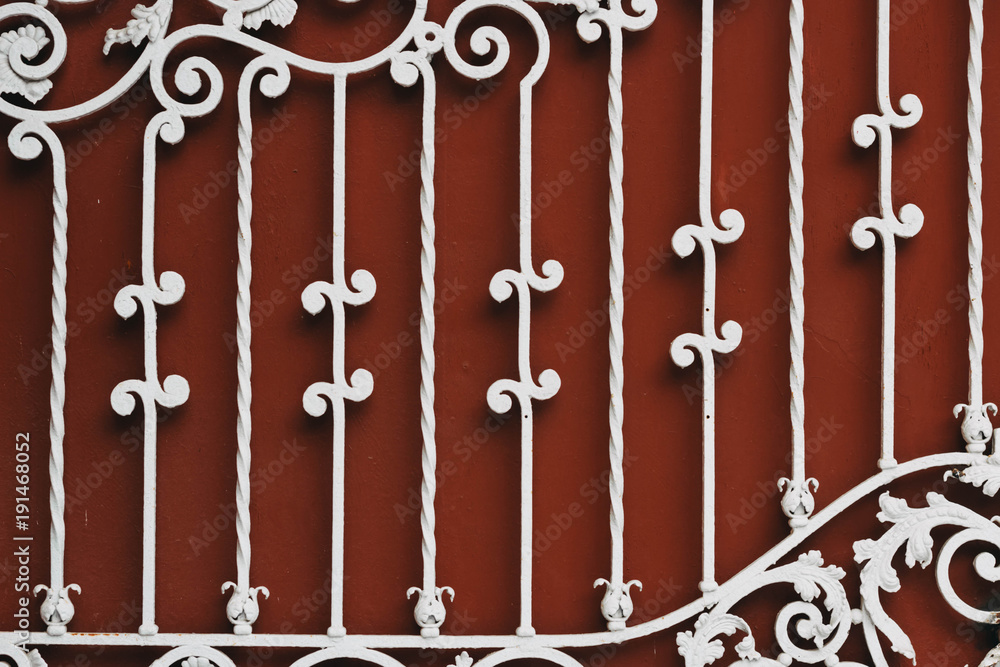 red iron gate with white forged pattern red iron gate with white forged pattern
