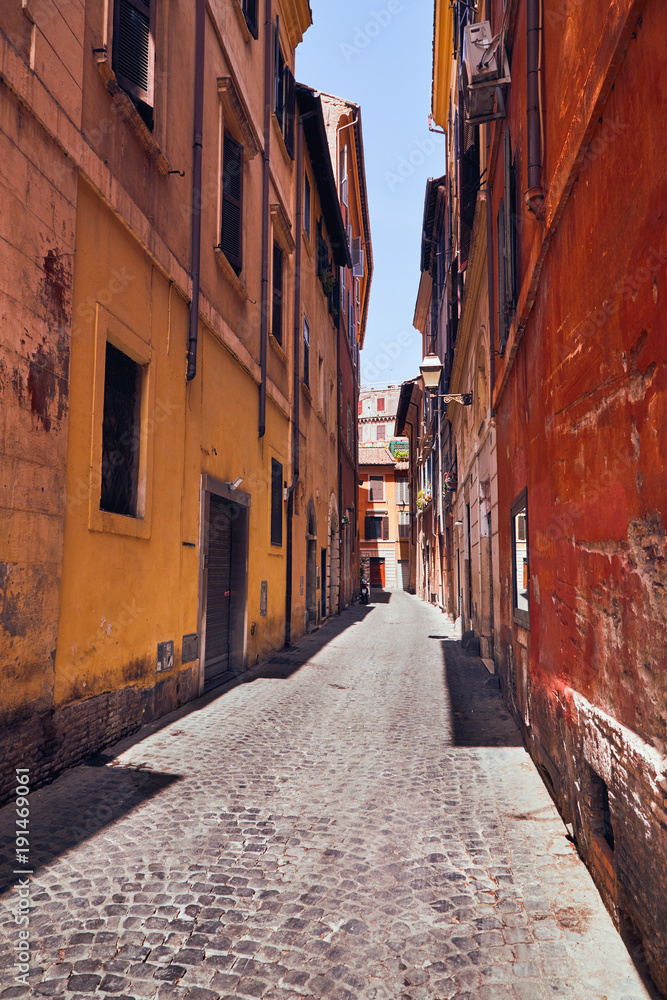 
Narrow Italian street with colorful houses without people on a sunny day Rome, Italy