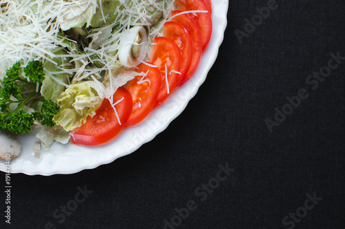 on a dark fabric background iceberg lettuce, with quail eggs, flat lay photo