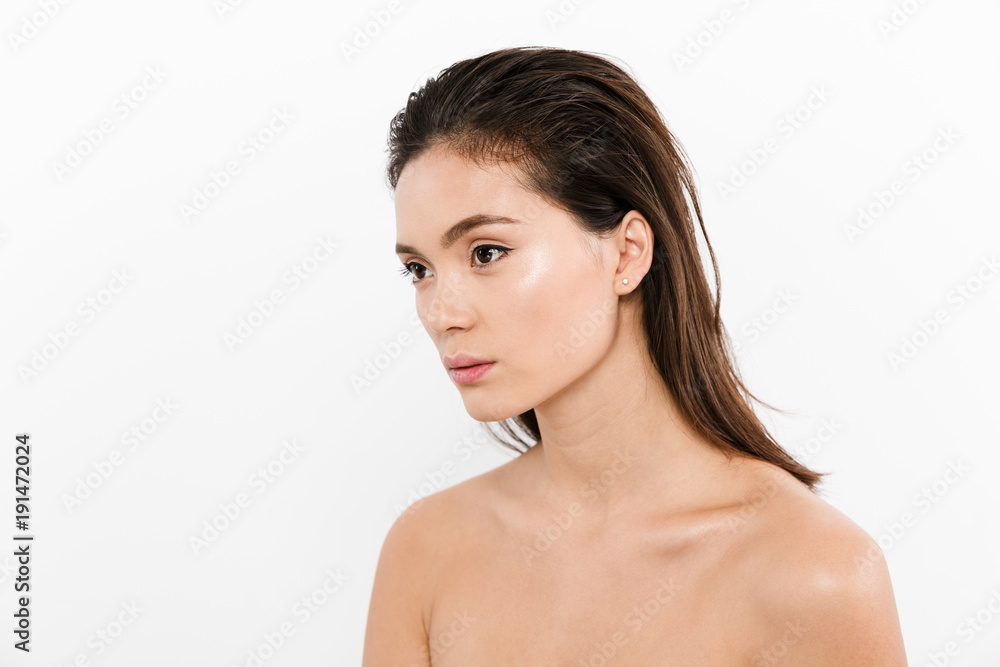 Half-turn portrait of nude asian woman with wet brown hair looking aside, isolated over white background Half-turn portrait of nude asian woman with wet brown hair looking aside, isolated over white background