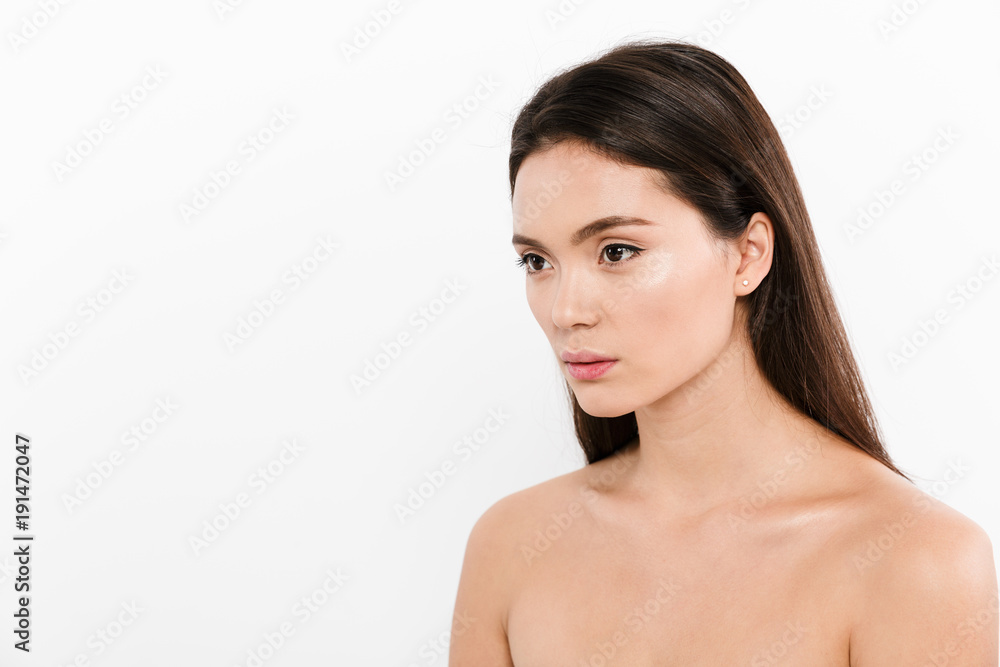 Beauty portrait in half-turn of asian pretty woman with brown long hair posing on camera, isolated over white background Beauty portrait in half-turn of asian pretty woman with brown long hair posing on camera, isolated over white background