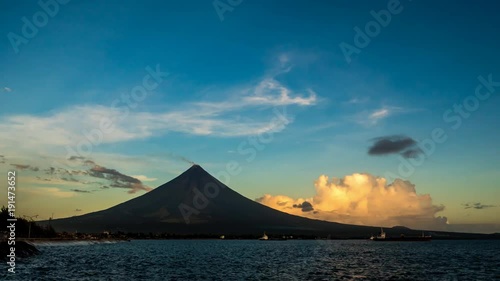 Timelapse morning and sunrise Mayon Volcano in Legazpi, Philippines. Mayon Volcano is an active volcano and rising 2462 meters from the shores of the Gulf of Albay. photo