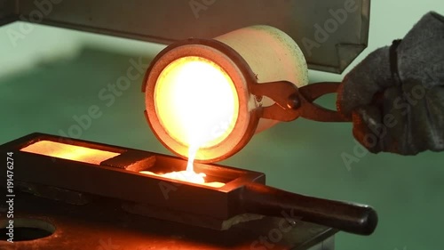 Melting gold. Molted metal pouring into bar form
