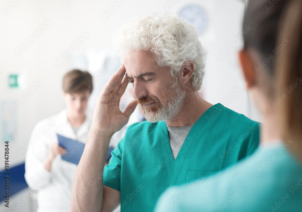 Healthcare worker having an headache Healthcare worker having an headache