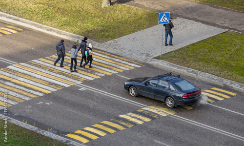 People cross the road on the crosswalk