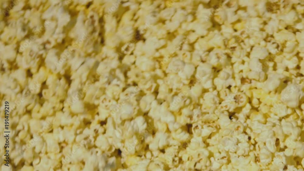 View of popcorn circling in the bowl during the cooking. Slowly View of popcorn circling in the bowl during the cooking. Slowly