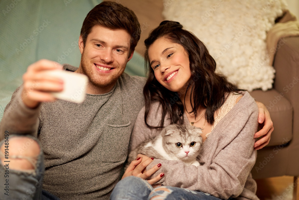 happy couple taking selfie by smartphone at home happy couple taking selfie by smartphone at home