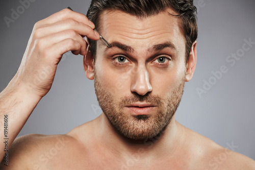 Close up portrait of a confident shirtless man