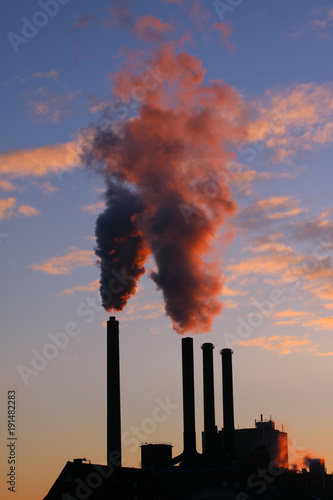 Heavy cloud of smoke from industrial chimney in sunset with copy space