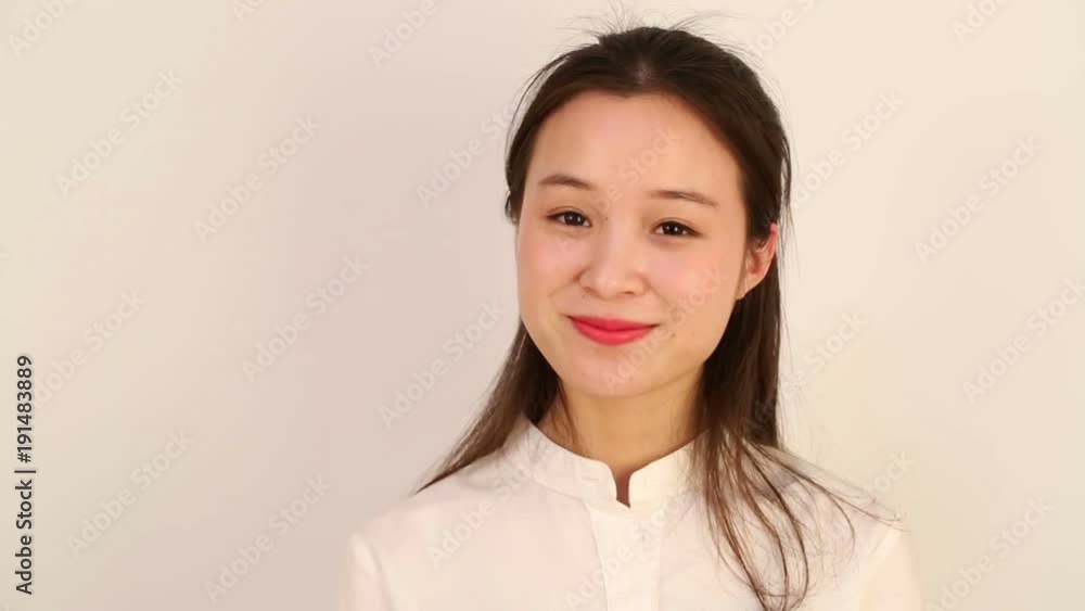 Young woman with a lovely smile and nodded, and looking at camera. Young woman with a lovely smile and nodded, and looking at camera.