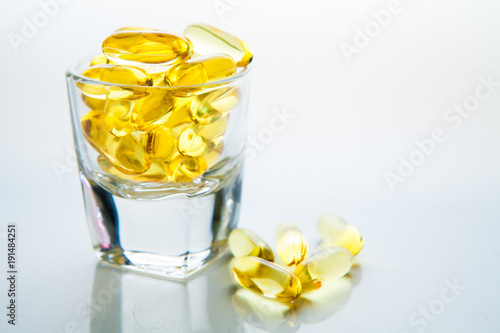 Fish oil soft capsule in glass isolated on white background.with copy space